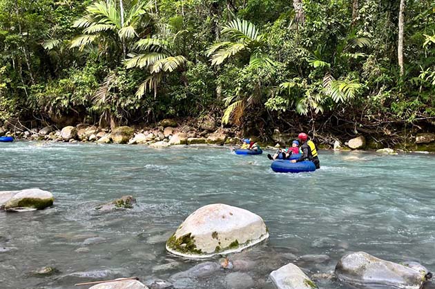 Experience an exhilarating ride tubing down a rocky river surrounded by lush greenery and tropical plants with Tubing in Rincón de la Vieja.